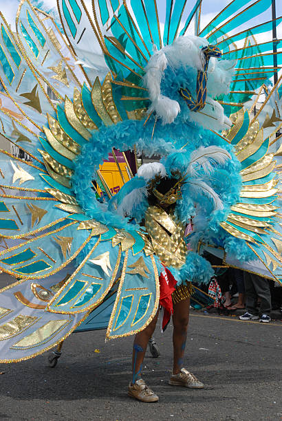 Woman in a carnival parade as a blue peacock  One of the many flamboyant costumes at the Notting Hill Carnival, London notting hill photos stock pictures, royalty-free photos & images