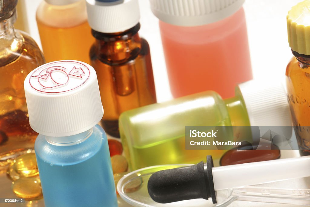 medical or science background Medicine bottles, capsules, an eyedropper and a dosage spoon. Addiction Stock Photo