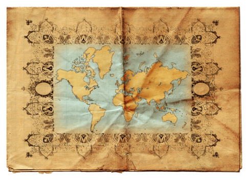 A sheet of vintage grungy paper creased and marked with a map of the world on it