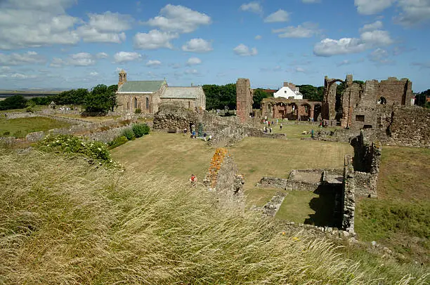 "The ruins of Lindisfarne Priory, Northumberland, North East England.St Mary's church on left. The Priory was the scene of Viking attacks in the 8th and 9th centuries."