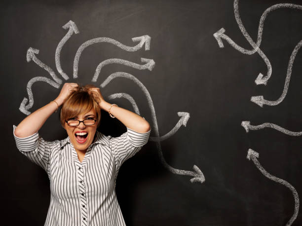 istock Businesswomen Pulling Her Hair Out with Arrows on the Blackboard 172309683