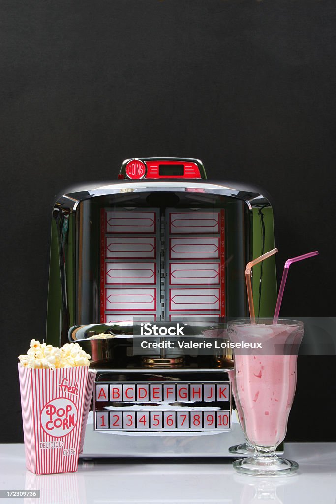 Tabletop Jukebox and foods Tabletop Jukebox with popcorn and Strawberry Milkshake. Diner Stock Photo