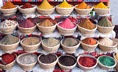 An Egyptian spice market with baskets full of spice