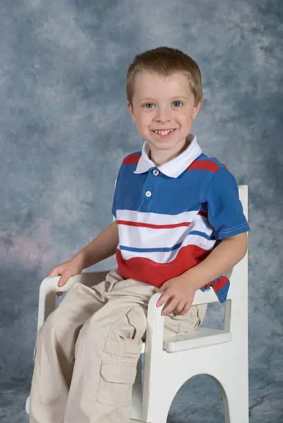 "Shown here is an image of a seated, cute, blue eyed, preschool age boy posing for his school picture.See other related images here:"