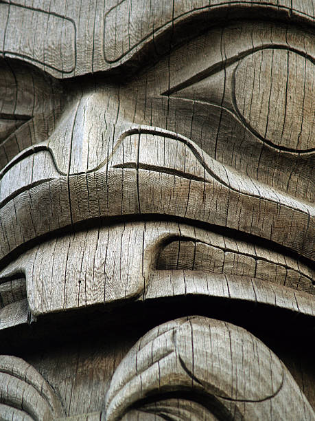 Natural wood totem, close-up detail Close up on a natural wood totem pole in the Pacific Northwest. pacific northwest totem poles stock pictures, royalty-free photos & images