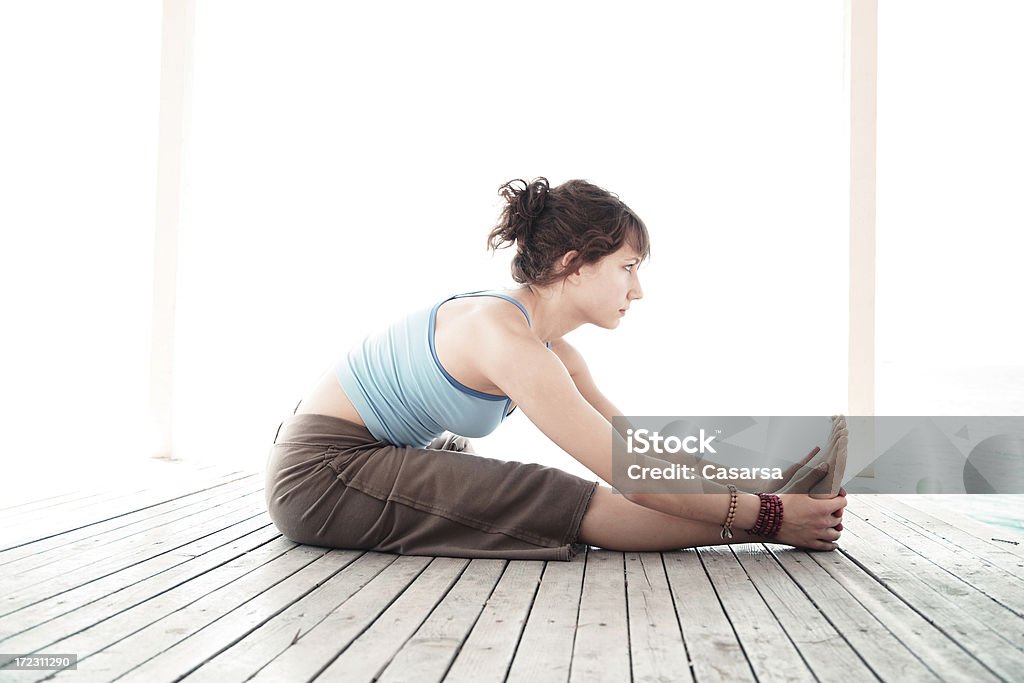 Yoga - Paschimottanasana Young girl practicing yoga. 20-24 Years Stock Photo