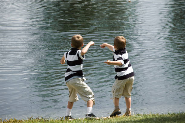 istock Twin Boys Throwing Rocks 02 172311300
