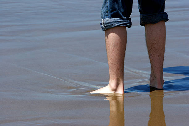 Standing in Wet Sand stock photo