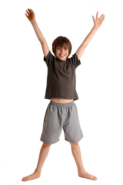 Happy boy arms and legs spread as an X stock photo