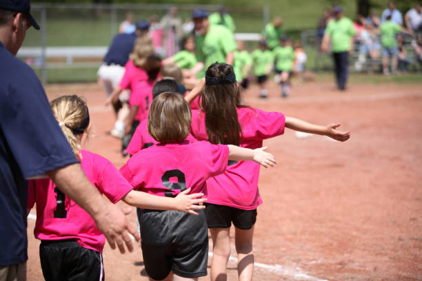 Young girls in pink and black sports gear playing outside stock photo