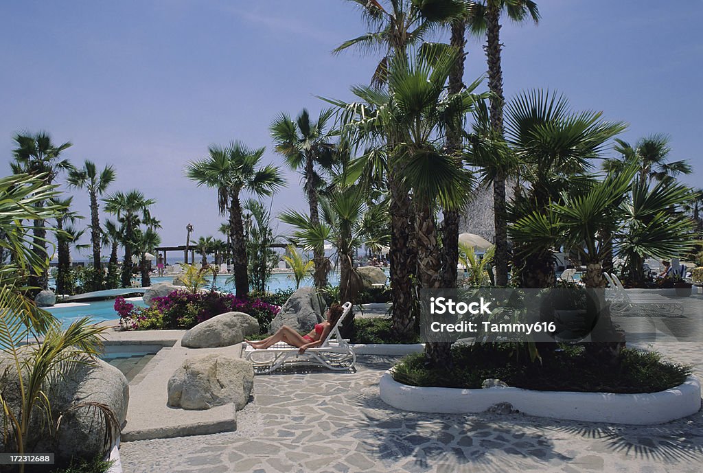 Donna di relax a bordo piscina - Foto stock royalty-free di Abbronzarsi