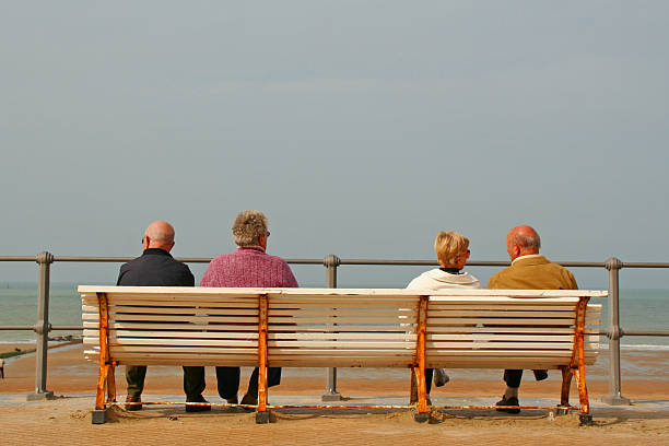 istock Elderly couples on bench at the beach 172312968
