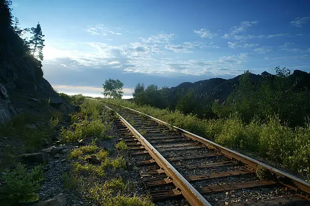 Railway track by the field and mountain of baie St-Paul Quebec