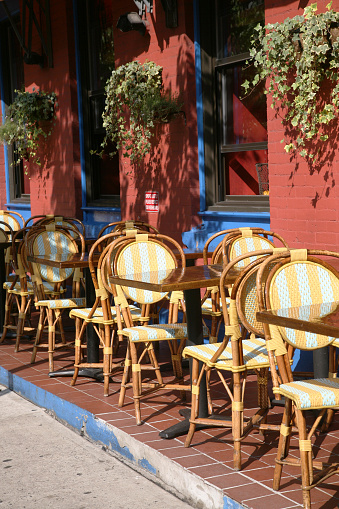 Empty restaurant tables and chairs outdoor in SoHo, New York City, New York, USA.
