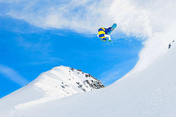 istock Freestyle snowboarder in a jump 172315635