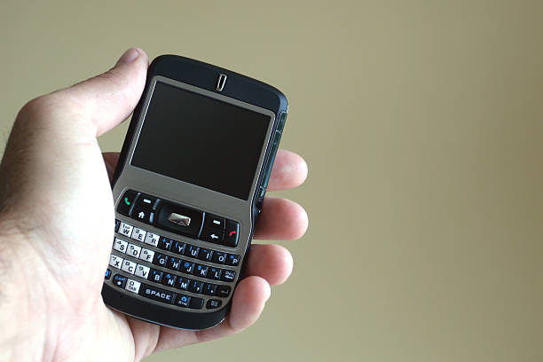 istock Human Hand Holding a Mobile Phone on Neutral Background 172316191