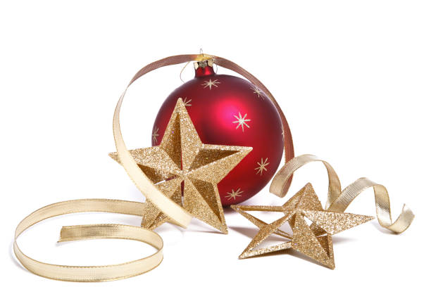 A golden Christmas star and a Christmas bauble on white.  