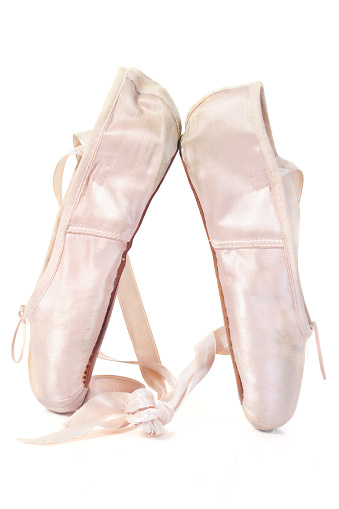 Ballet slippers on a white background.