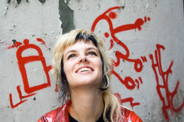 istock Young hippy woman smiling with graffitti 172317583