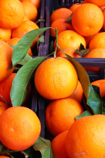Stack of oranges in a street market stall.