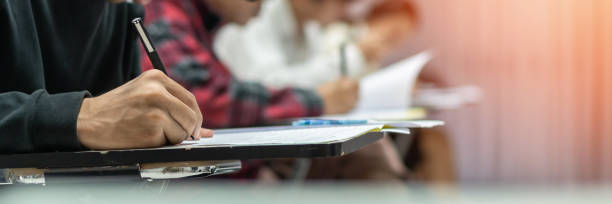 istock Exam at school with student's taking educational admission test in class, thinking hard, writing answer in university classroom, education and world literacy day concept 1723184233