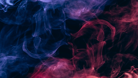 Color smoke. Vapor cloud. Esoteric energy. Neon pink blue glowing gas mist mix texture on dark black copy space abstract background.