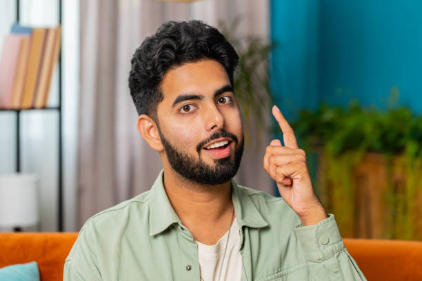 istock Thoughtful inspired Indian man make Eureka gesture raises finger came up with creative plan at home 1723188666