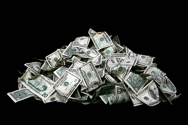 Mounds of Cash Large stack of cash isolated on black background. huge pile of money stock pictures, royalty-free photos & images