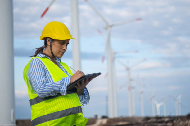 istock Pregnant wind energy engineer working at wind farm. 1723195829