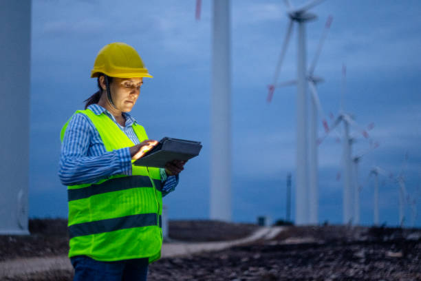 istock Pregnant wind energy engineer working late at wind farm. 1723195849