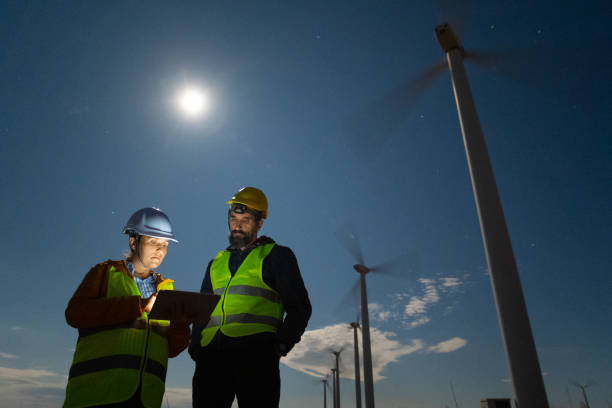 istock Pregnant wind engineer working in team at night in wind farm. 1723195856