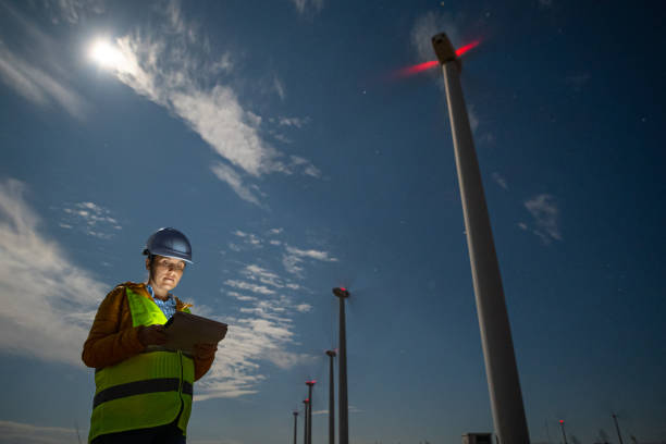istock Pregnant wind energy engineer working late at wind farm. 1723195859