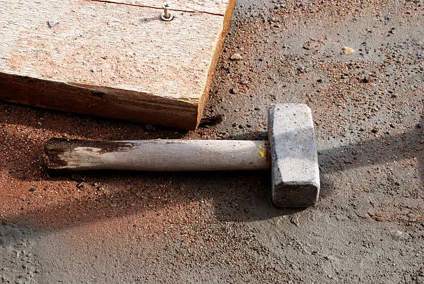 "hammer and plank, construction site still life."