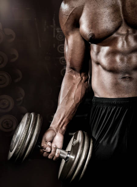 istock Athlete doing bicep curl in gym 172320074