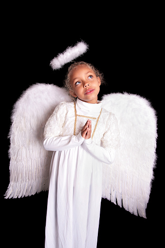 Little girl in an angel costume, with her hands clasped as if praying. Please view all pictures of this model