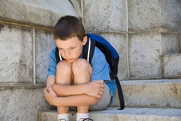 istock Little boy hugging his knees in desperation 172321064