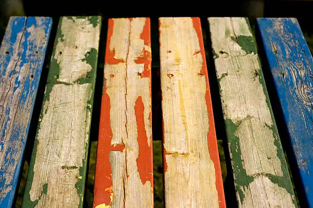 Part of an old table with painted wooden boards. The norwegian winters have been tearing the paint off gradually.