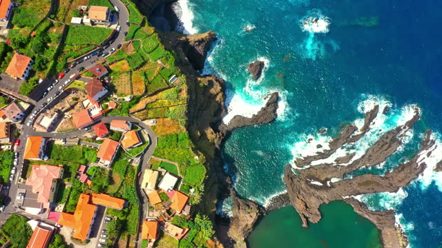 AERIAL Directly Above View of Seixal Town on Madeira Island along Sea, Portugal