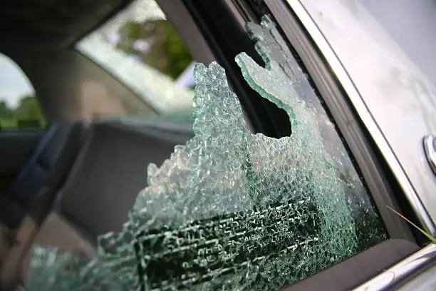 "smashed out car glass, many jagged little pieces. Rear window also smashed in, if you look closely."