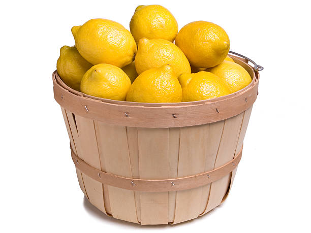 Lemons in a Wood Basket on a White Background