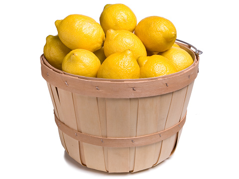 Lemons in a Wood Basket on a White Background
