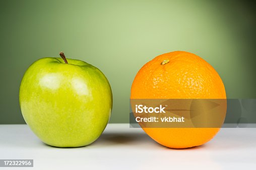 istock An apple sitting next to an orange 172322956