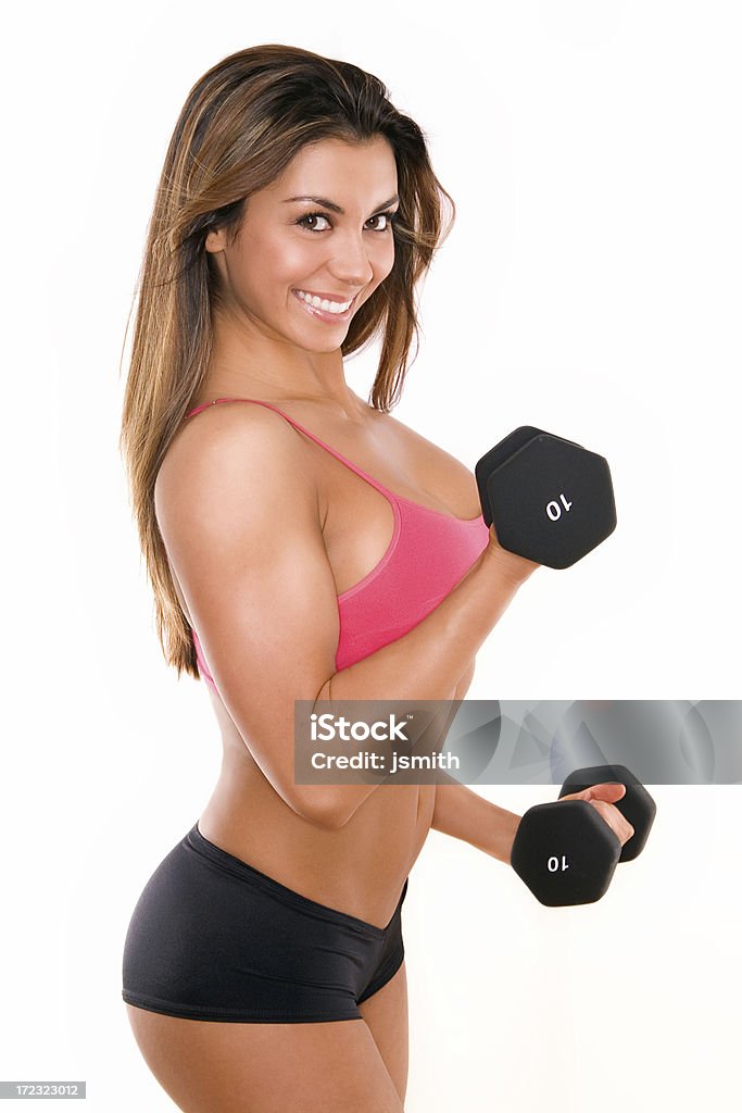 Female Fitness Series "Beautiful and very athletically fit woman curls dumbbells with a winning smile.May work well for fitness magazine, health club or diet plan marketing." Abdominal Muscle Stock Photo