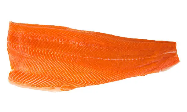 A fillet of Copper River sockeye salmon, orange, raw, fresh fish meat food, isolated on a white background.