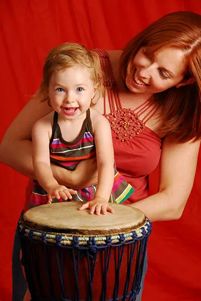 A young girl loves to play the drum!