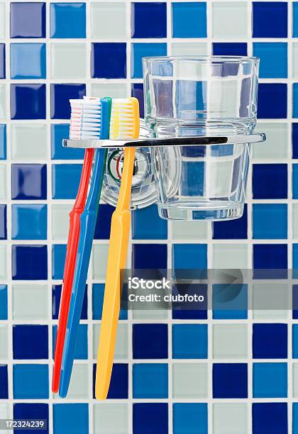 Toothbrushes And Holder On A Tiled Wall Stock Photo - Download Image Now - Bathroom, Drinking Glass, Blue