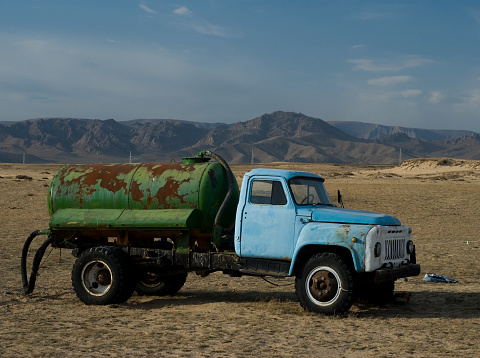 A rusty old truck parked on the steppe in the Mongolia wilderness