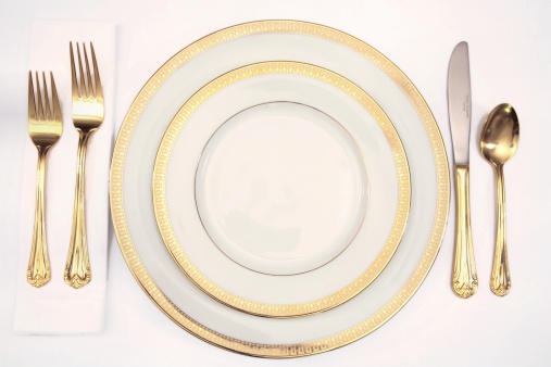 Place setting in gold and white.Click below to view more table settings