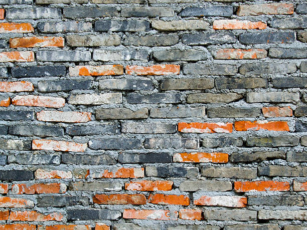 Brick wall with different colored bricks stock photo