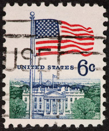 1960's postage stamp of the White House and flag.